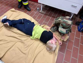 Kind in stabiler Seitenlag auf Decke liegend